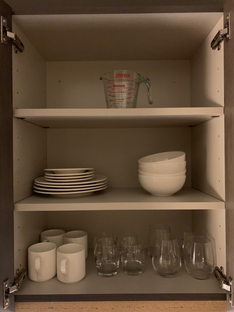 a shelf with plates and glasses