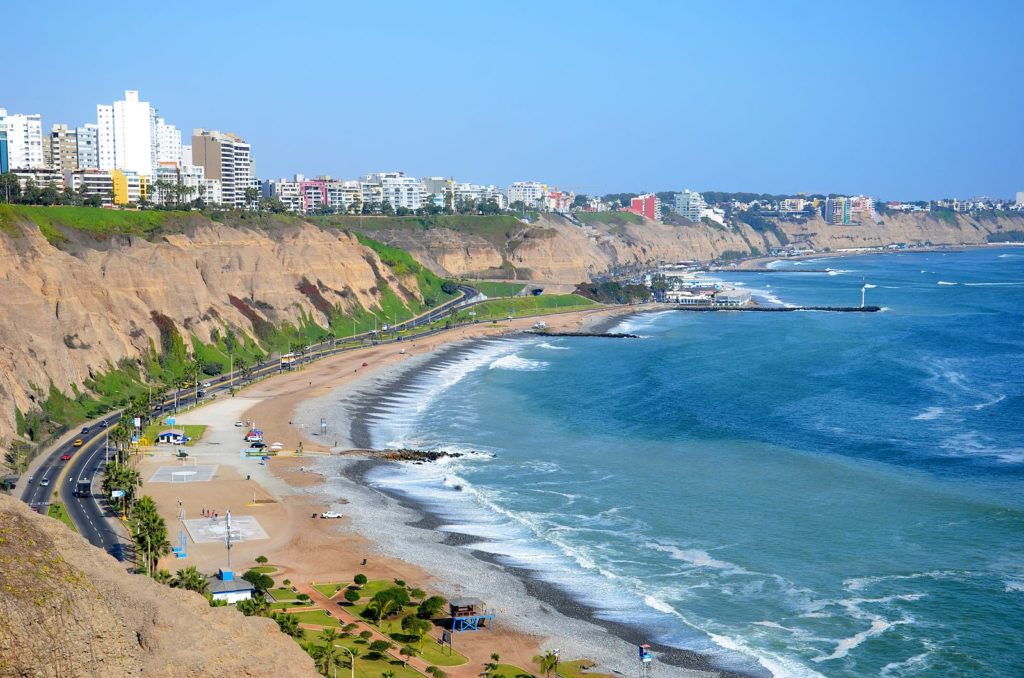 a beach with buildings and a body of water