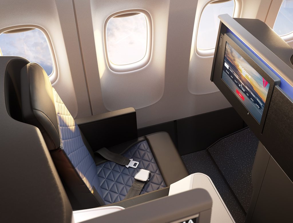 a seat in an airplane with a tv and a screen