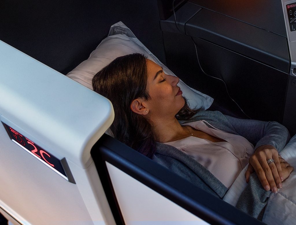 a woman sleeping on a plane