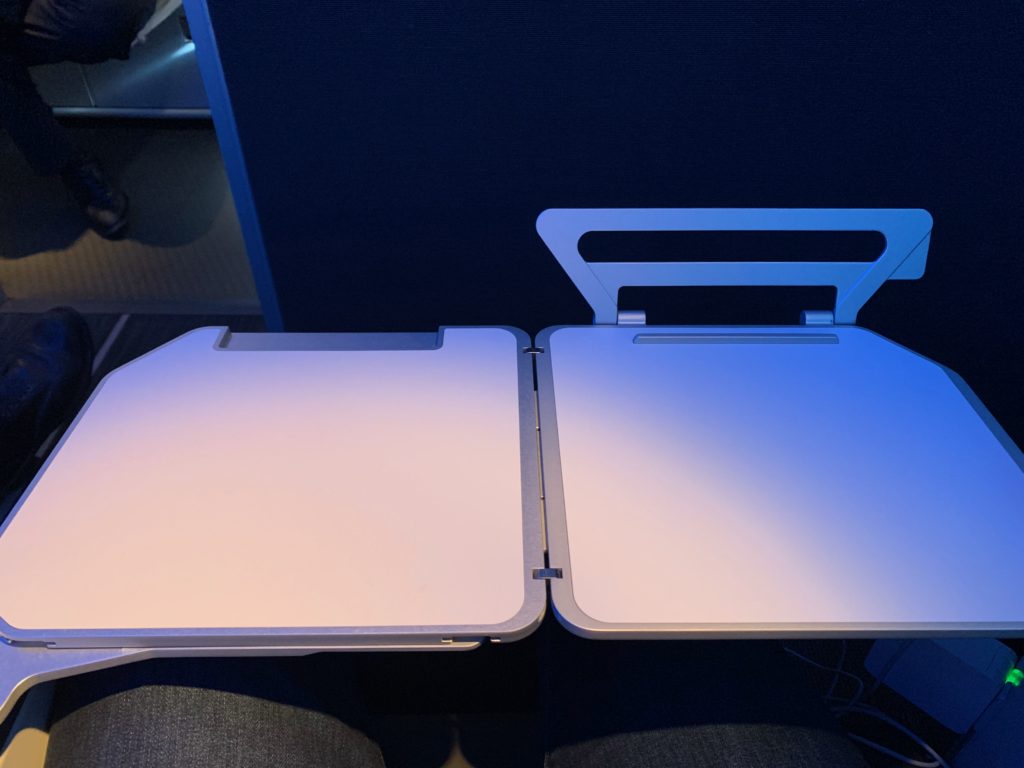 a pair of laptops on a person's lap