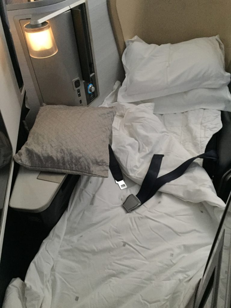 a seat belt and pillows on a bed