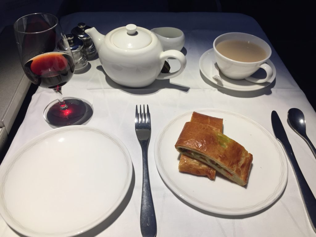 a plate of food and a teapot on a table