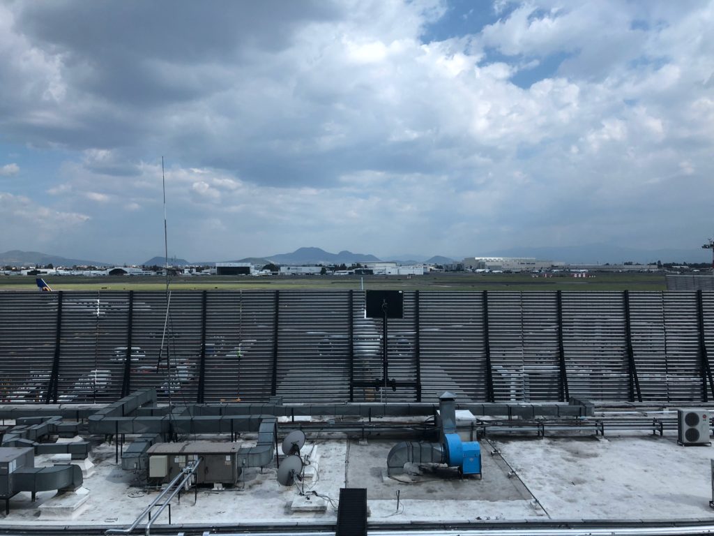 a large stadium with a large field and a cloudy sky