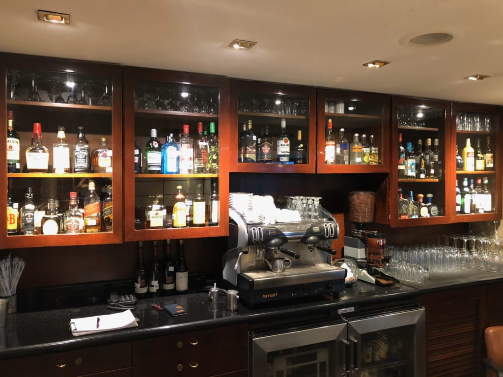 a bar with liquor bottles and glasses