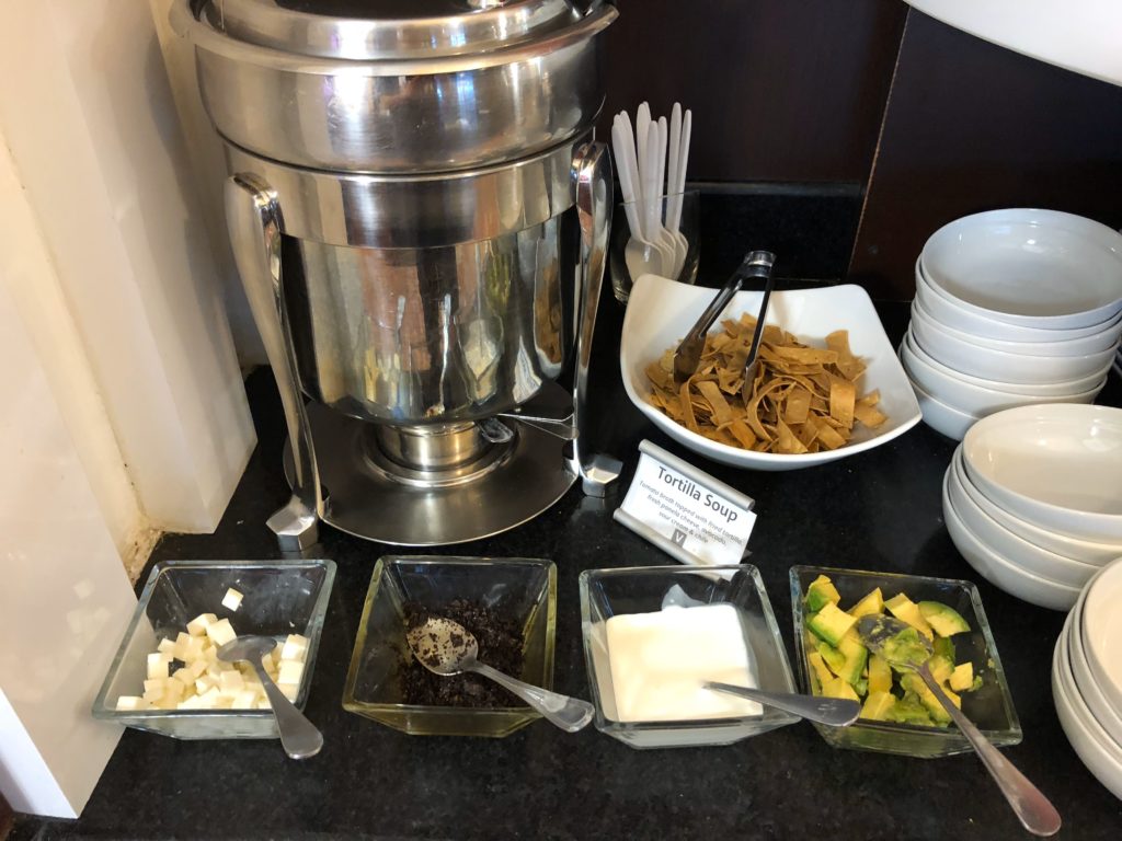 a table with bowls of food and utensils