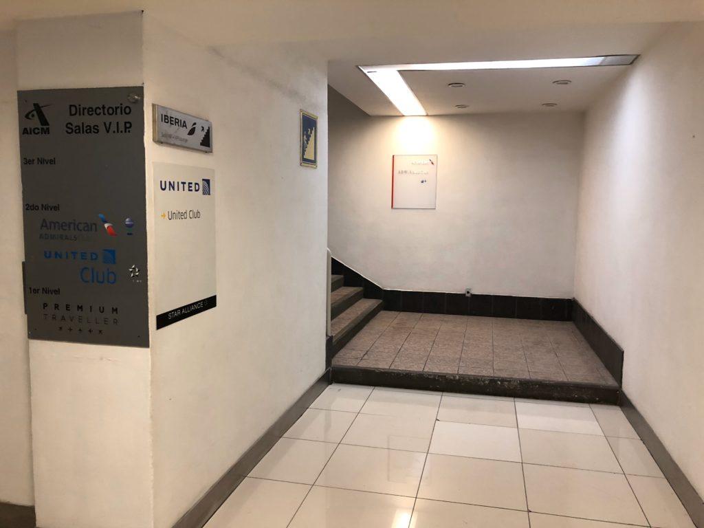 a hallway with stairs and signs