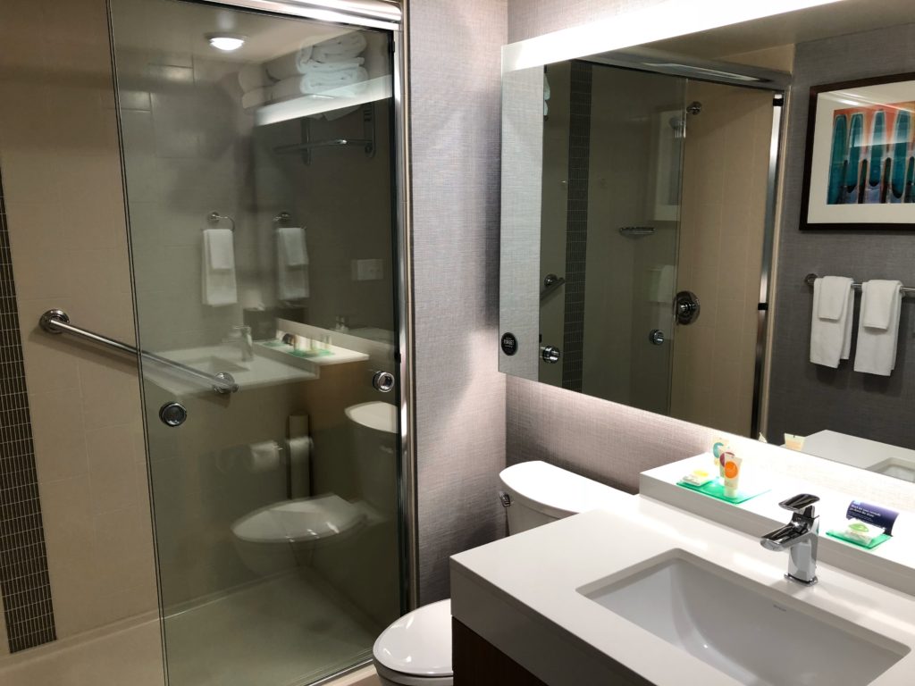 a bathroom with a glass shower door