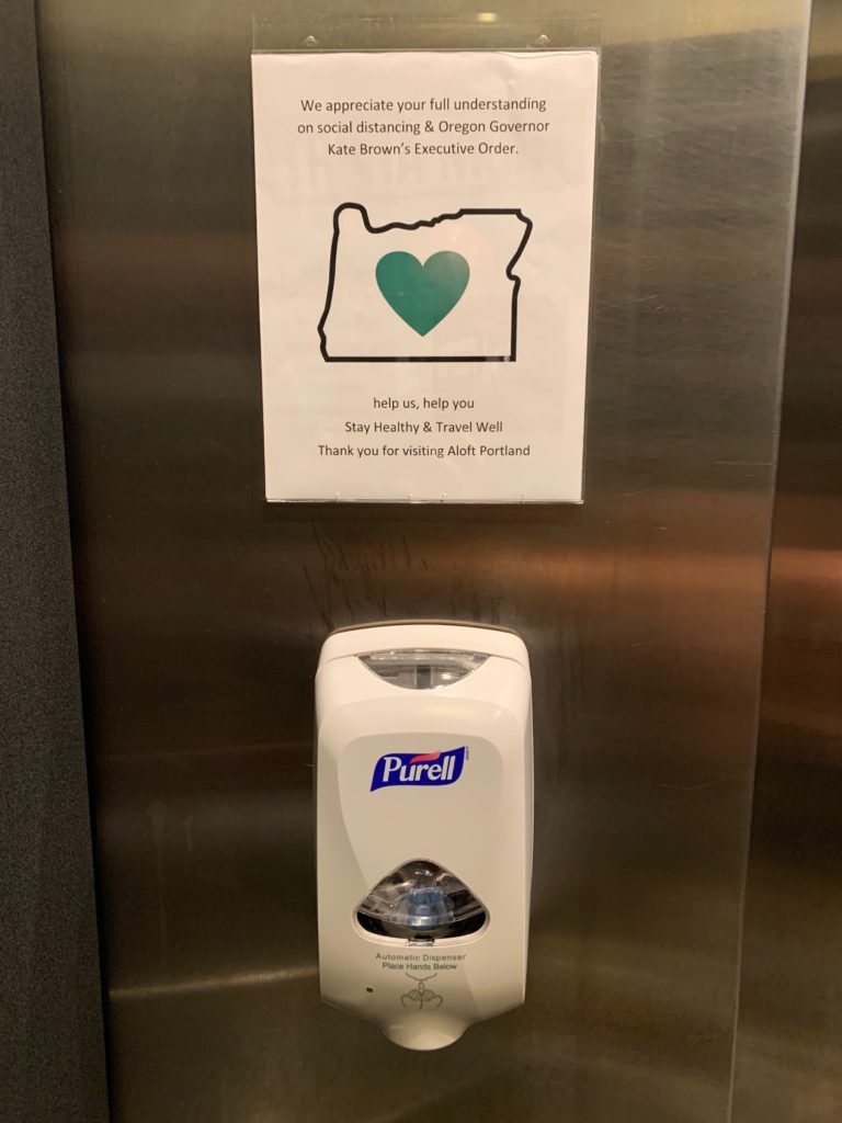 a hand sanitizer dispenser on a wall