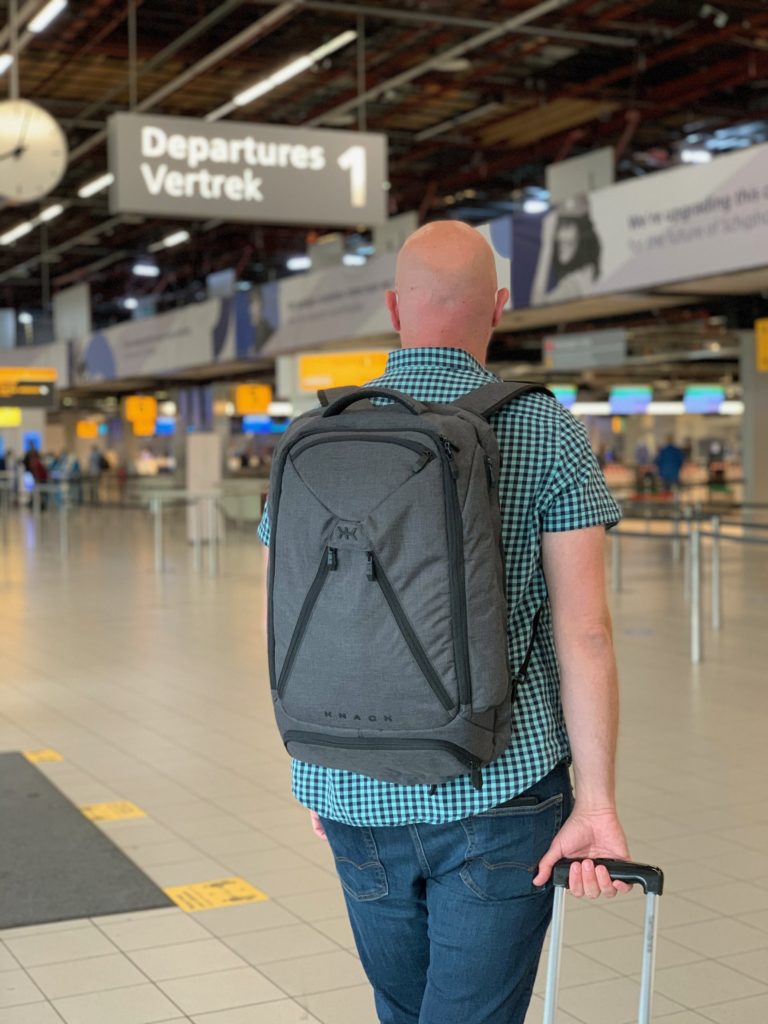 a man with a backpack in an airport