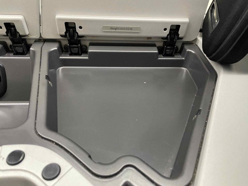 a grey plastic container in an airplane