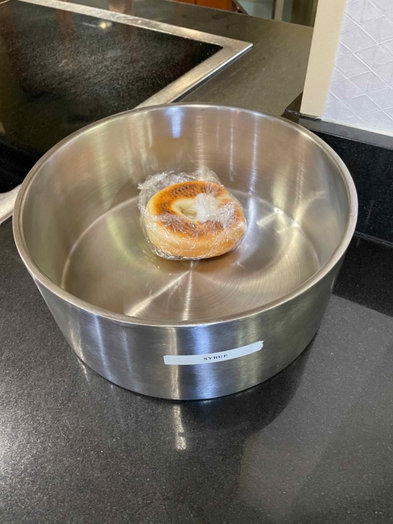 a bagel in a bowl of water