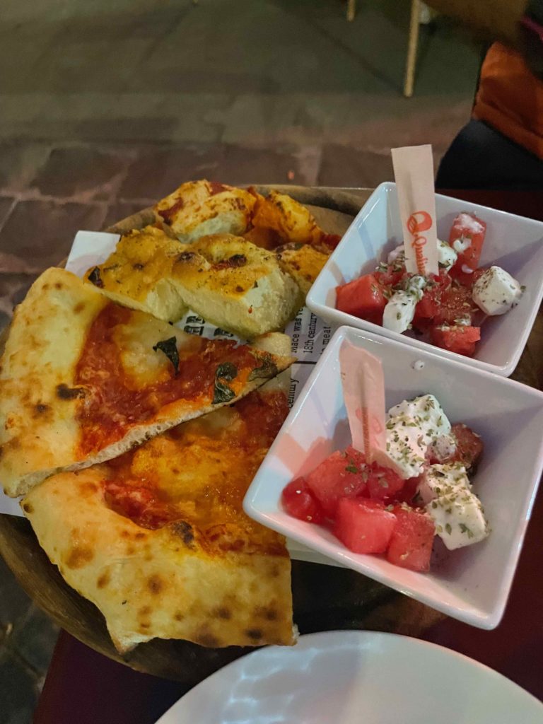 a plate of pizza and fruit