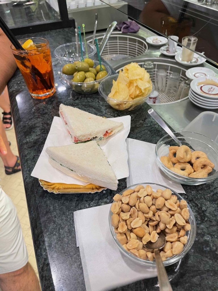 a sandwich and snacks on a counter