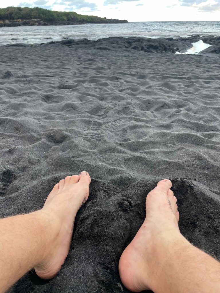 a person's feet on a beach