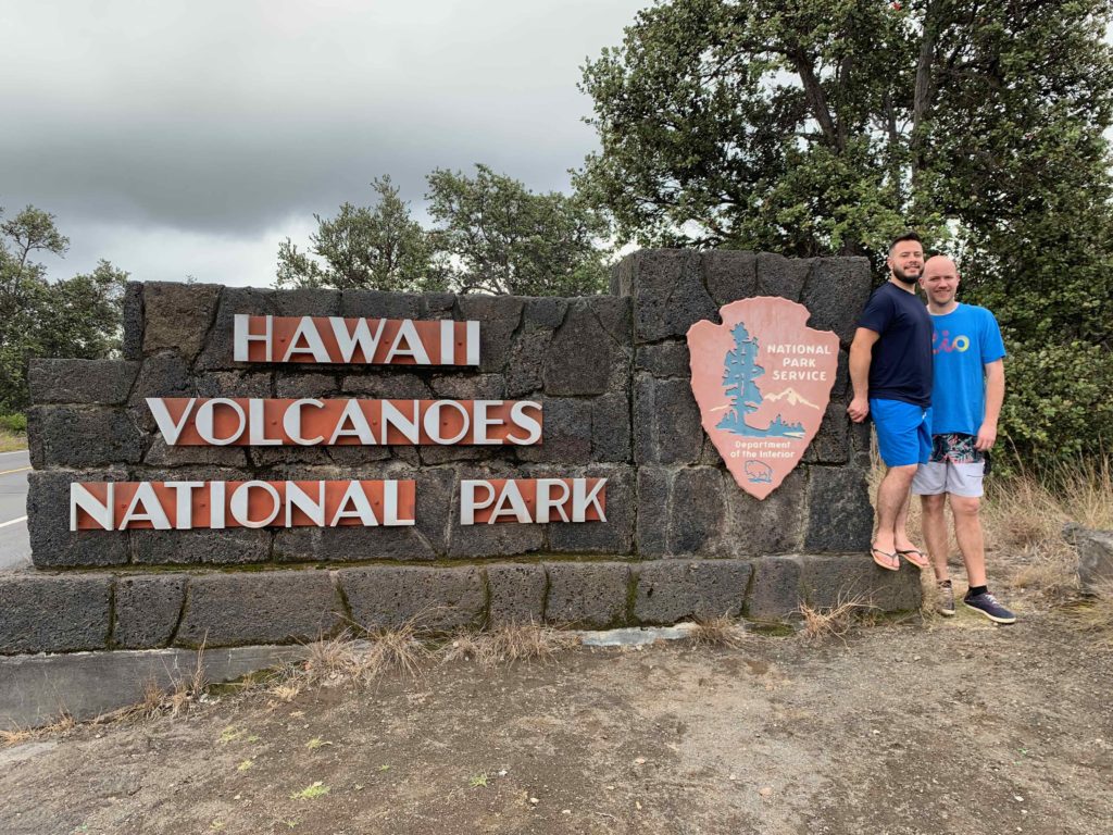 two men standing in front of a sign