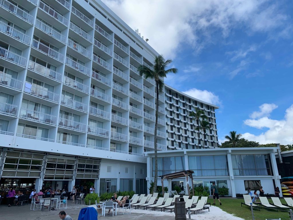 a large white building with many windows and chairs