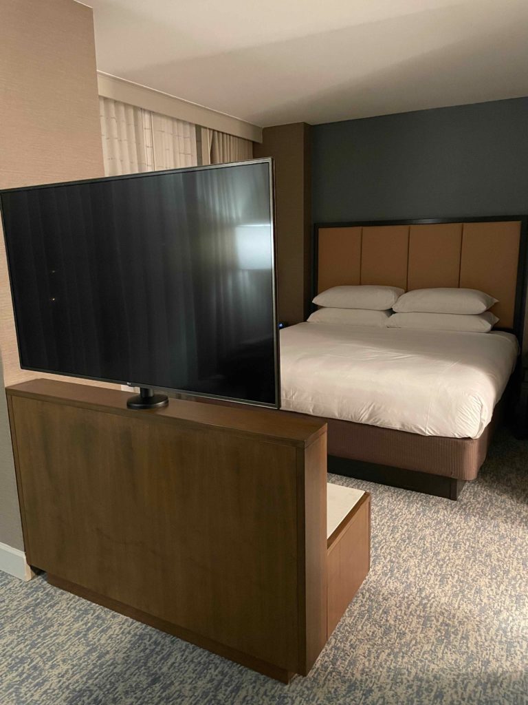a tv on a stand in a hotel room