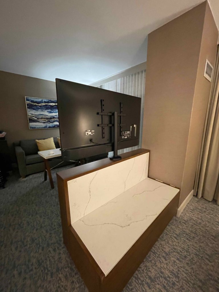 a tv on a bench in a room