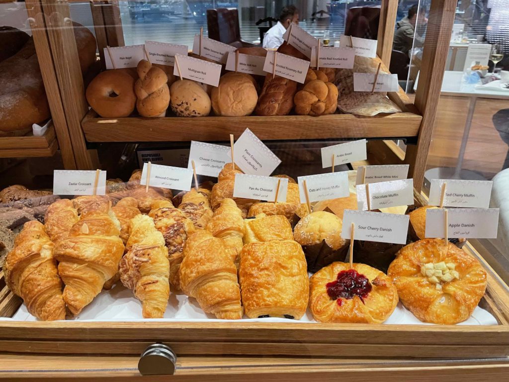 a display case of pastries and bread