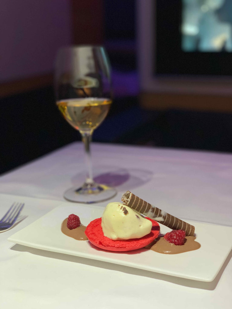 a plate of dessert with a glass of wine