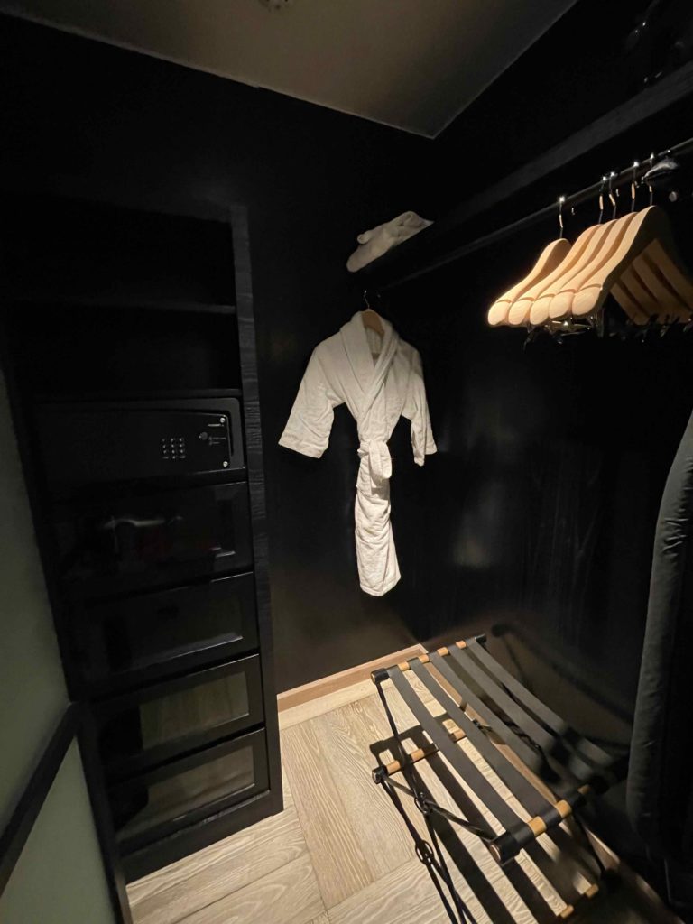 a white robe from a swinger in a black room