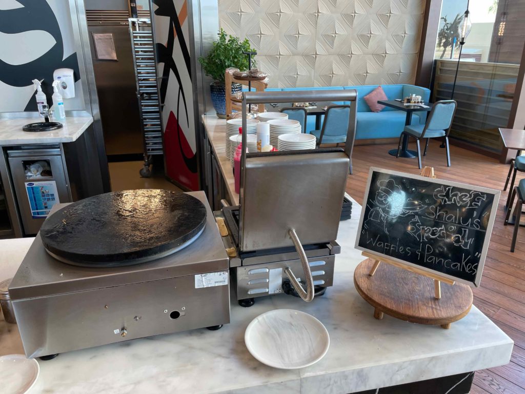 a kitchen with a waffle maker and plates