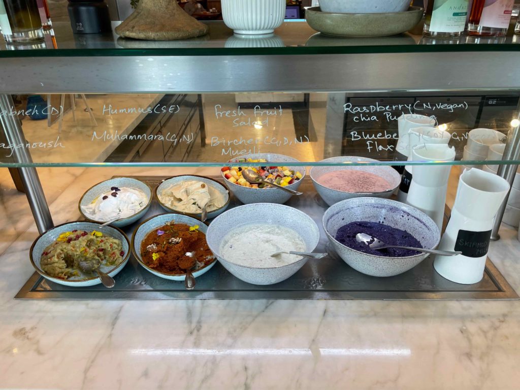 a glass display case with different types of food