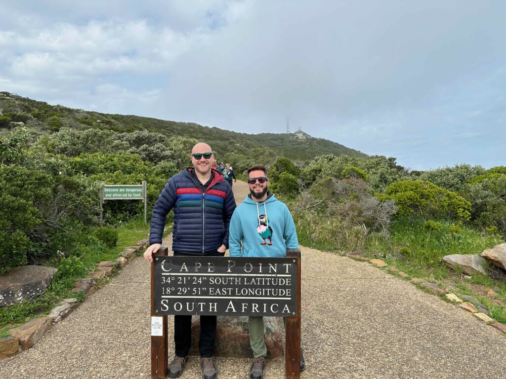two men standing in front of a sign in Cape Town